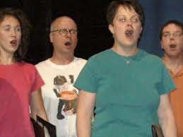 Downsbrough (2nd from left) singing during a UT promotional event.