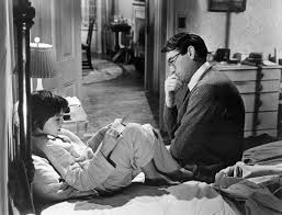 Mary Badham as Scout and Gregory Peck as Atticus in the movie version of To Kill a Mockingbird.