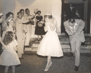 Mama and Daddy dodging rice as they dash for the getaway car after their 1956 wedding.